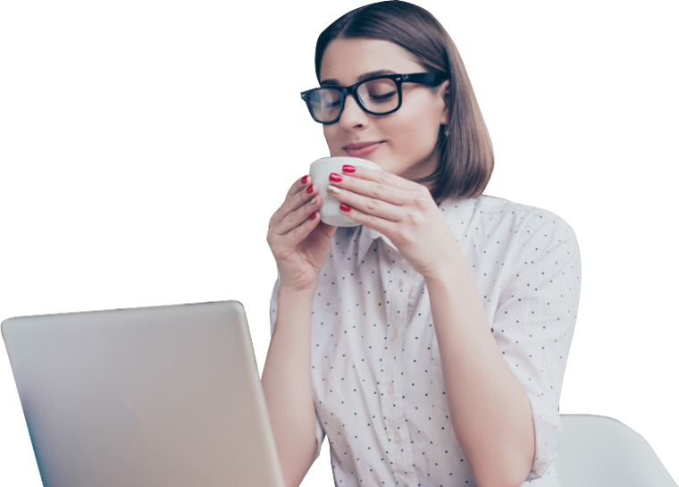 Millennial woman with brown hair and glasses sitting down drinking coffee with laptop on table